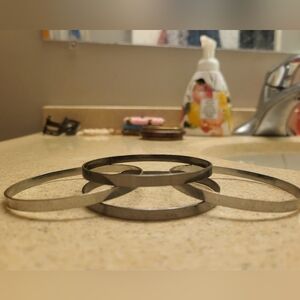 Four smooth metal bracelets